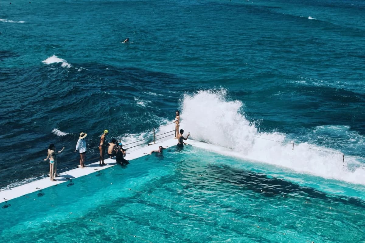 Waves breaking over the edge of an ocean swimming pool